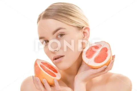 The cute woman holding a grapefruit on the white background Stock Photos