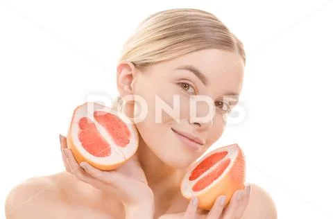 The cute woman holding a grapefruit on the white background Stock Photos