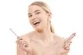 The cute woman holding a lip gloss on the white background Photo