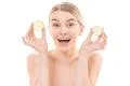 The cute woman holding two halves of a lemon on the white background Photo