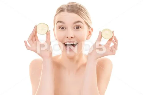 The cute woman holding two halves of a lemon on the white background Stock Photos