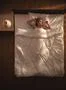 The cute woman lay on the bed and gesture. View from above Photo