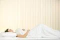 The cute woman lay on the bed and smile Photo