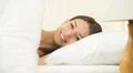 The cute woman lay on the bed and smile Photo