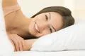 The cute woman lay on the bed and smile Photo