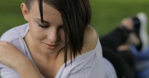 Cute woman lying on the grass and relax at summer day Stock Footage