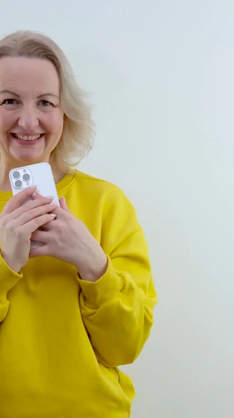 Cute woman plotting something holding a phone in her hands wants to call someone Stock Footage 244485445
