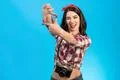 The cute woman with an retro camera gesturing on the blue background Photo