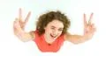 The cute woman show two finger to the camera. View from above Photo