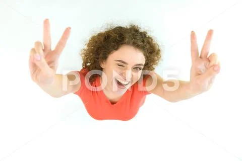The cute woman show two finger to the camera. View from above Stock Photos