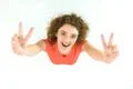 The cute woman show two finger to the camera. View from above Photo