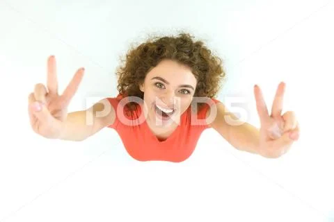 The cute woman show two finger to the camera. View from above Stock Photos