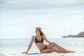 The cute woman sit against the background of the sea Photo