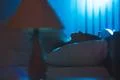 The cute woman sleeping on the bed. Evening night time Photo