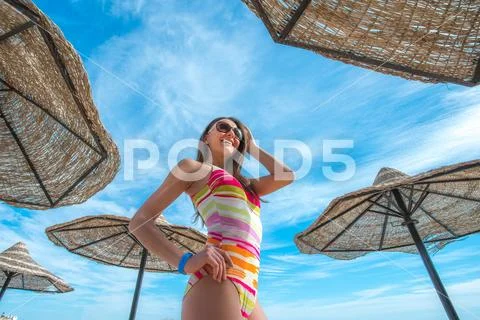 The cute woman stand in the beach on the sea background Stock Photos