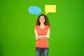 The cute woman stand with a dialog signs on the green background Photo