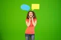 The cute woman stand with a dialog signs on the green background Photo