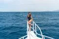 The cute woman stand in the yacht on the sea background Photo