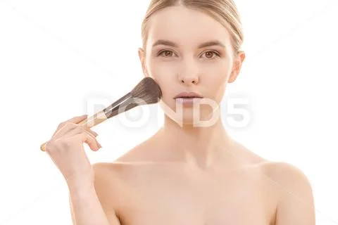 The cute woman using a cosmetic brush on the white background Stock Photos