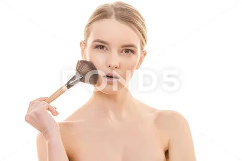 The cute woman using a cosmetic brush on the white background Stock Photos