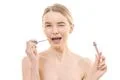 The cute woman using a lip gloss on the white background Photo