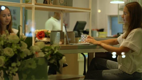 Cute woman using a notebook in a cafe Stock Footage 119040974