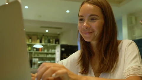Cute woman using a notebook in a cafe Stock Footage 119041259