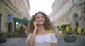 The cute woman walk and phone on the street. Slow motion. Wide angle 4k or 4k+ Resolution