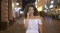 The cute woman walk and phone on the street. Slow motion. Wide angle 4k or 4k+ Resolution