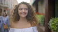 The cute woman walk on the street. Slow motion. Wide angle 4k or 4k+ Resolution