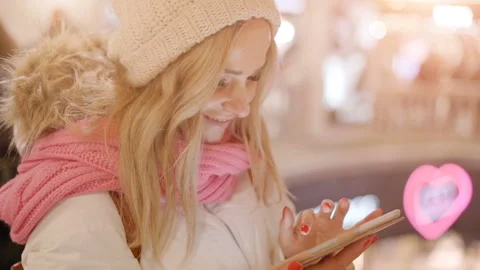 Cute woman in winter clothes using tablet in shopping mall Stock Footage 100681466