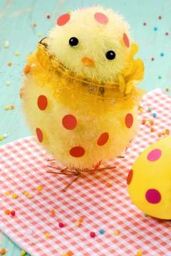 Cute yellow easter chick, easter egg in polka dots on red napkin. 写真素材