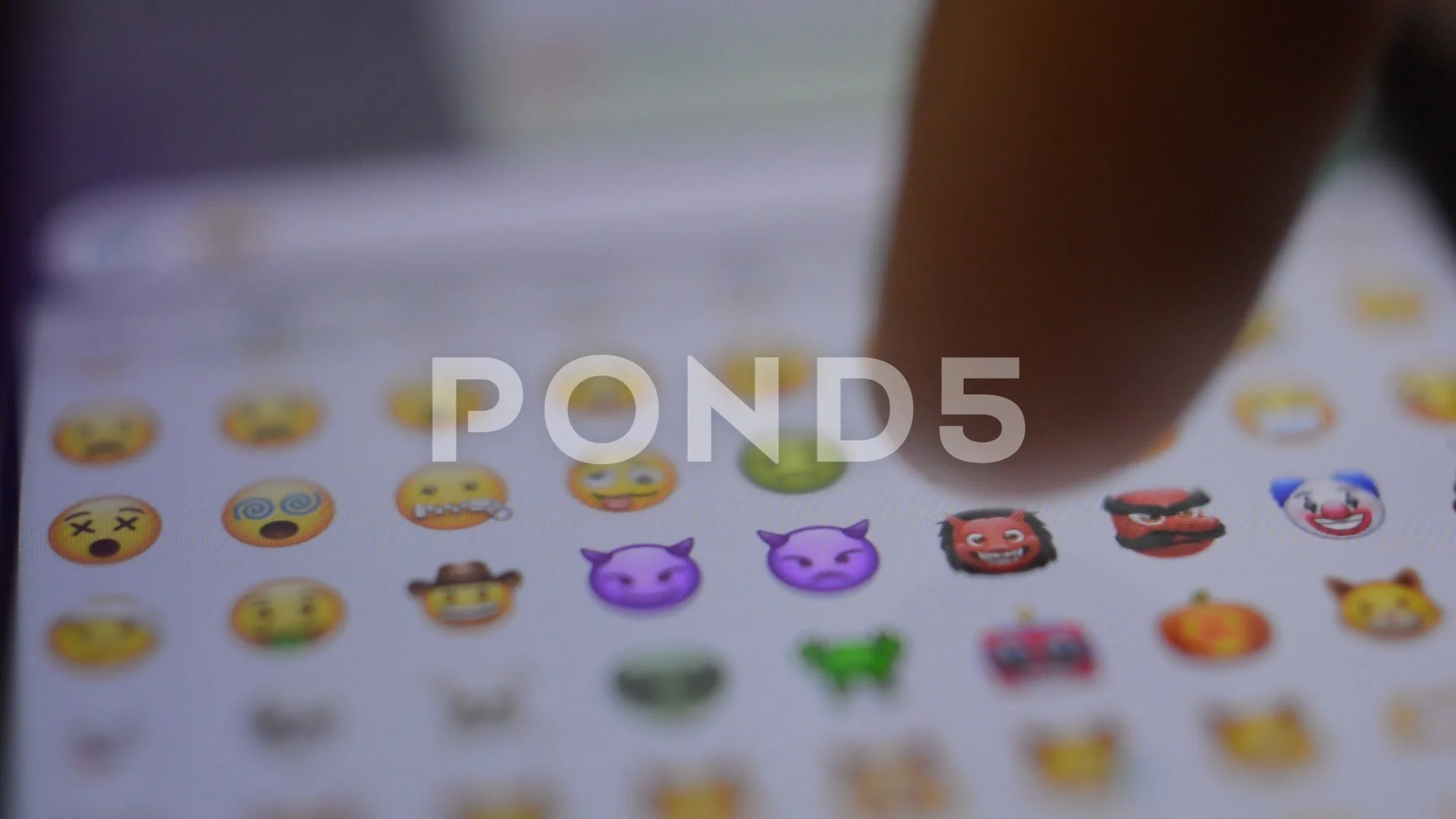 cute yellow emoticon on the iphone keybo... | Stock Video | Pond5