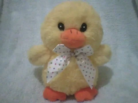 Cute yellow stuffed chick with white bow painted with colorful polka dots Video stock 162146349