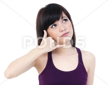 Cute young asian woman making a call me gesture Stock Photos
