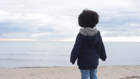 Cute young black boy on beach yelling over water Stock Footage 88958538