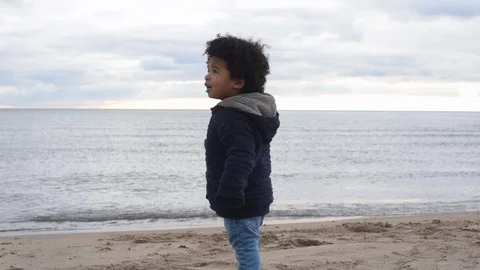 Cute young black boy on beach walking 库存影片 88958722