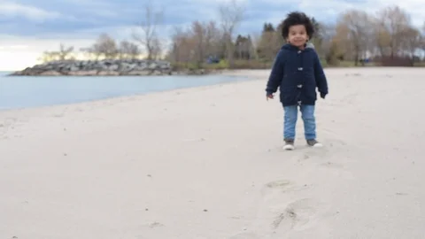 Cute young black boy running on beach Stock Footage 88930775