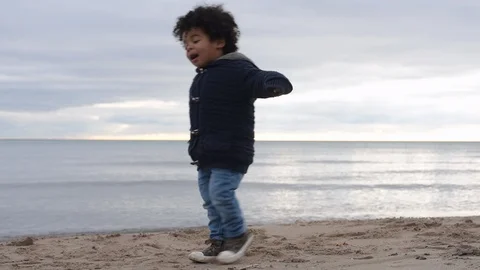 Cute young black boy walking on beach Stock Footage 88955816