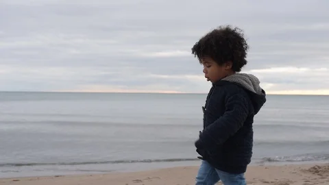 Cute young black boy walking on beach Stock Footage 88956255