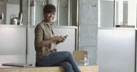 Cute young black woman in loft style office Stock Footage