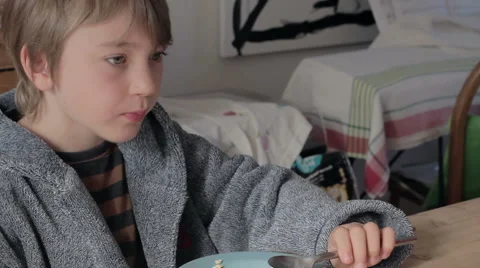 Cute young blonde boy eats cereal Stock Footage 42513996