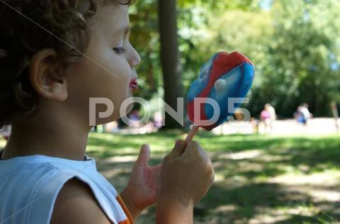 Cute Young Boy Eating Ice Cream Stock Photos