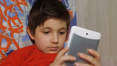 Cute young boy playing with smartphone. Childhood, technology, addiction Stock-Footage 90491496