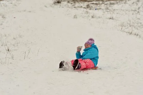 Cute young boy smiling while he is sledding Stock Photos