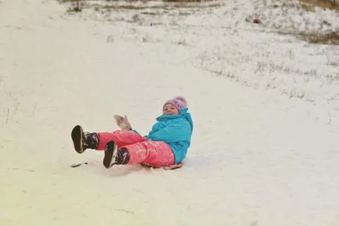 Cute young boy smiling while he is sledding Stock Photos
