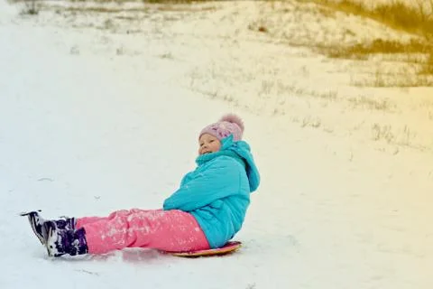 Cute young boy smiling while he is sledding Stock Photos