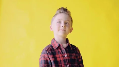 Cute young boy thought about a new idea, looks thoughtfully and dreamily upwards Stock Footage 77554908