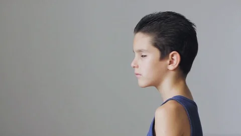 Cute young boy turns into the camera and smiling Stock Footage 111971780