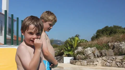 Cute young brothers playing in the pool on summer vacation 스톡 동영상 32936257